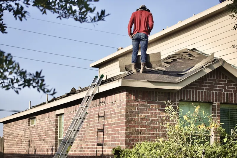 Professional roofer working on a residential roof in Lake Norman of Catawba